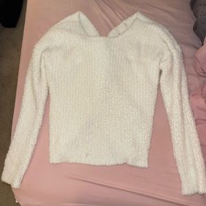 Cream fuzzy sweater with crossing detail